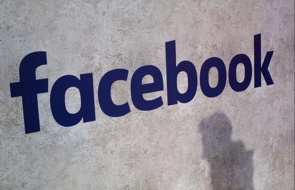 FILE - This Jan. 17, 2017, file photo shows a Facebook logo displayed in a start-up companies gathering.