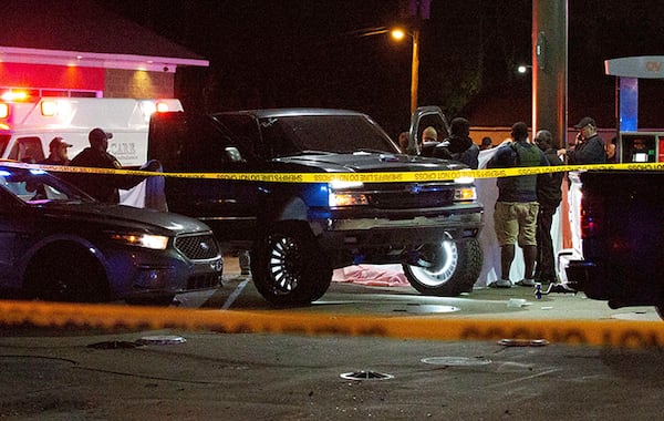 Deputies, police  and state law enforcement work the scene of a QV gas station in Hayneville, Ala., where Lowndes County Sheriff John Williams was shot and killed Nov. 23.