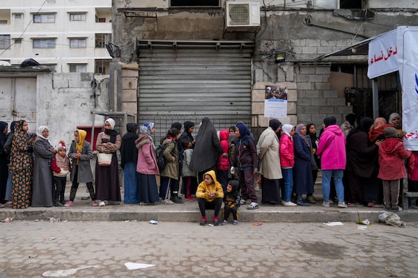 Palestinians queue to purchase bread outside a bakery in Gaza City, Monday, Feb. 24, 2025. (AP Photo/Abdel Kareem Hana)