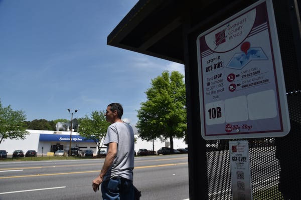 A customer waits for a Gwinnett County Transit at Buford Highway and N. Berkeley Lake Road on Wednesday, May 2, 2018. HYOSUB SHIN / HSHIN@AJC.COM