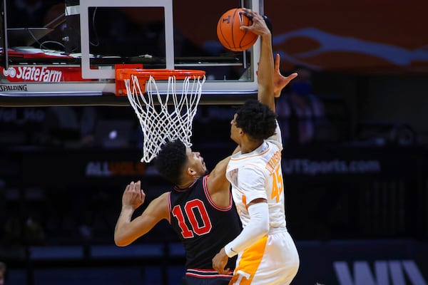 Tennessee's Keon Johnson (45) dunks against Georgia's Toumani Camara (10) during an NCAA college basketball game Wednesday, Feb. 10, 2021, in Knoxville, Tenn., in Knoxville, Tenn. (Randy Sartin/Pool Photo via AP)