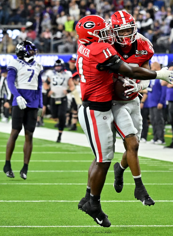 Georgia Bulldogs defensive backs Javon Bullard (22) and Kamari Lassiter (3) celebrate an interception against the TCU Horned Frogs during the first half of the College Football Playoff National Championship at SoFi Stadium in Los Angeles on Monday, January 9, 2023. (Hyosub Shin / Hyosub.Shin@ajc.com)