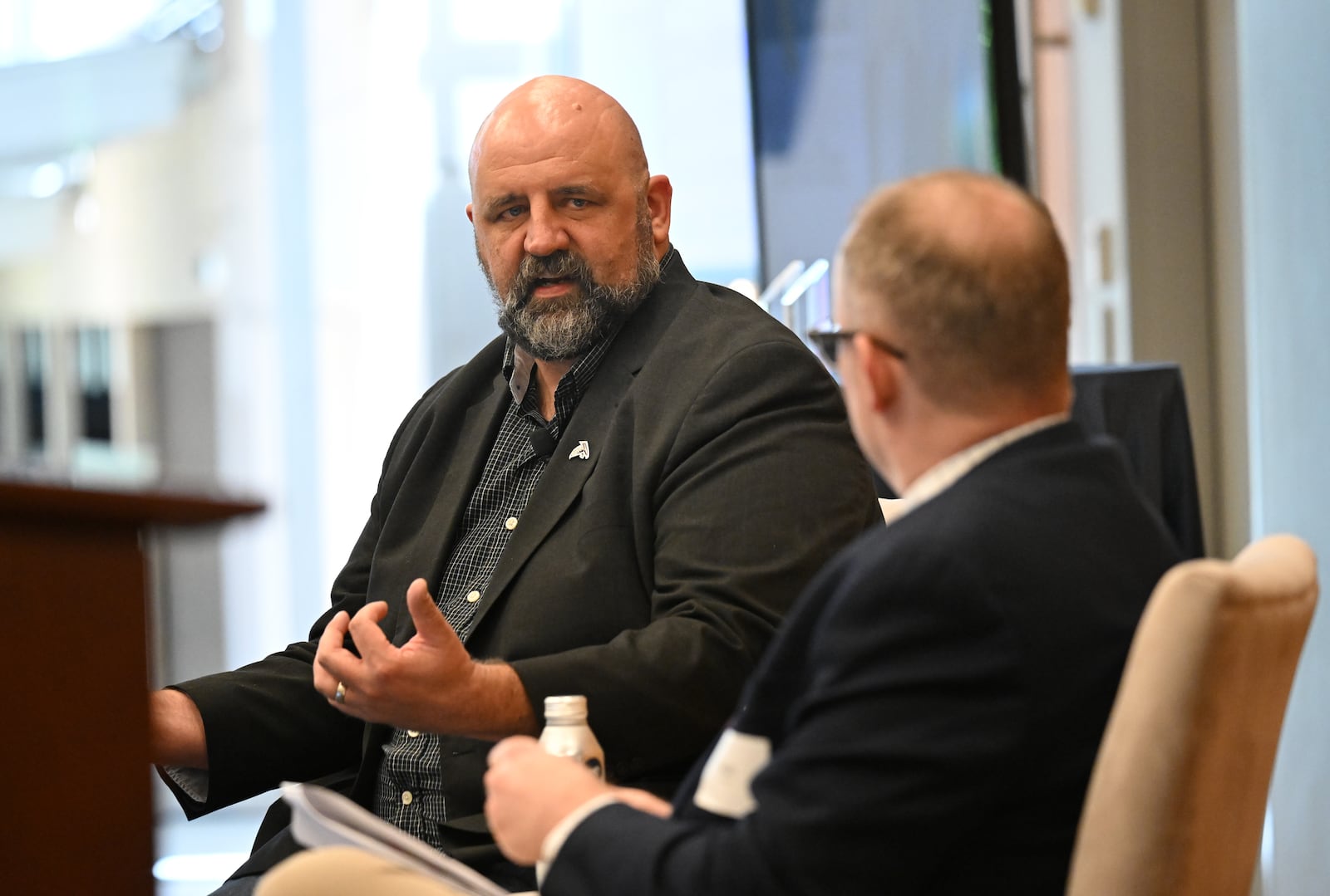 Karl Pierburg (left), a senior vice president and chief technology officer of football strategy and innovation with the Atlanta Falcons, speaks as Scott Trubey, senior business editor, moderates during a panel discussion about AI, Tech and the Atlanta Falcons, during The AJC Top Leaders event at Cox Headquarters, Thursday, October 10, 2024. (Hyosub Shin / AJC)