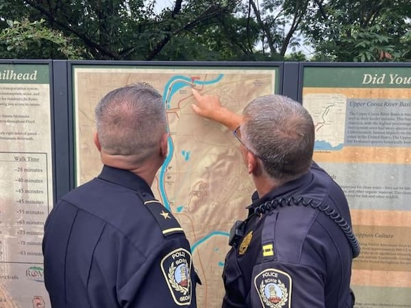 Rome Assistant Police Chief Rodney Bailey and another officer examine a map of the new Mount Berry Trail loop. (Photo Courtesy of Adam Carey)