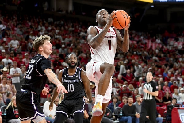 Arkansas guard Johnell Davis (1) drives past Lipscomb defenders Joe Anderson (22) and Gyasi Powell (10) during the second half of an NCAA college basketball game Wednesday, Nov. 6, 2024, in Fayetteville, Ark. (AP Photo/Michael Woods)