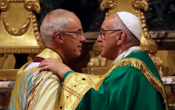 FILE - Pope Francis, right, greets the archbishop of Canterbury, Justin Welby, during vespers prayers in the church of San Gregorio al Celio, in Rome, Wednesday, Oct. 5, 2016. (AP Photo/Gregorio Borgia, File)