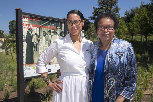 Karcheik Sims-Alvarado (left) and author Roslyn Pope pose for a portrait near a photo installation on the Atlanta Beltline near Gordon White Park. Sims-Alvarado is presenting a 4-mile-long exhibit of images from her book, “Images of America: Atlanta and the Civil Rights Movement, 1944-1968,” on the Atlanta Beltline. A photo of Pope’s appeal for human rights, which she drafted and presented in March 1960 during the height of the civil rights movement, is featured in the outside exhibit. ALYSSA POINTER / ALYSSA.POINTER@AJC.COM