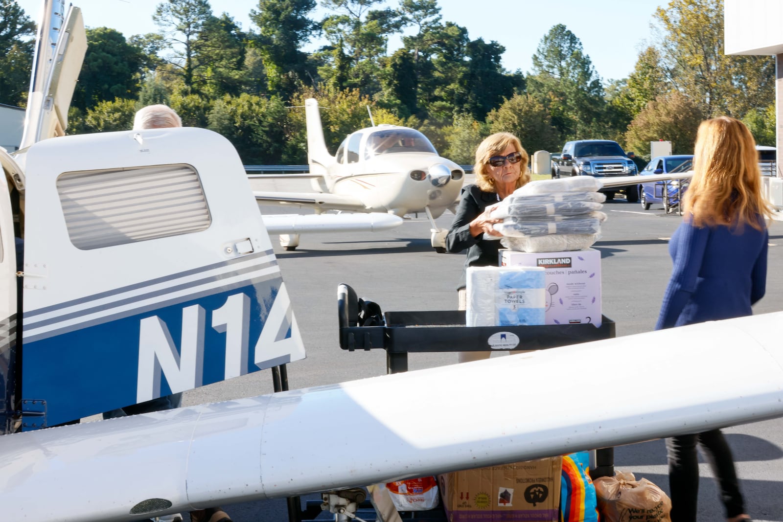 Bernadette Darnell (center) and her daughter, Jeanine Chambers, load airplanes with essential items at DeKalb-Peachtree Airport on Thursday, October 17, 2024. Together they run Angel Flight Soars, a nonprofit organization with volunteer pilots who transported supplies after Hurricane Helene. (Miguel Martinez / AJC)