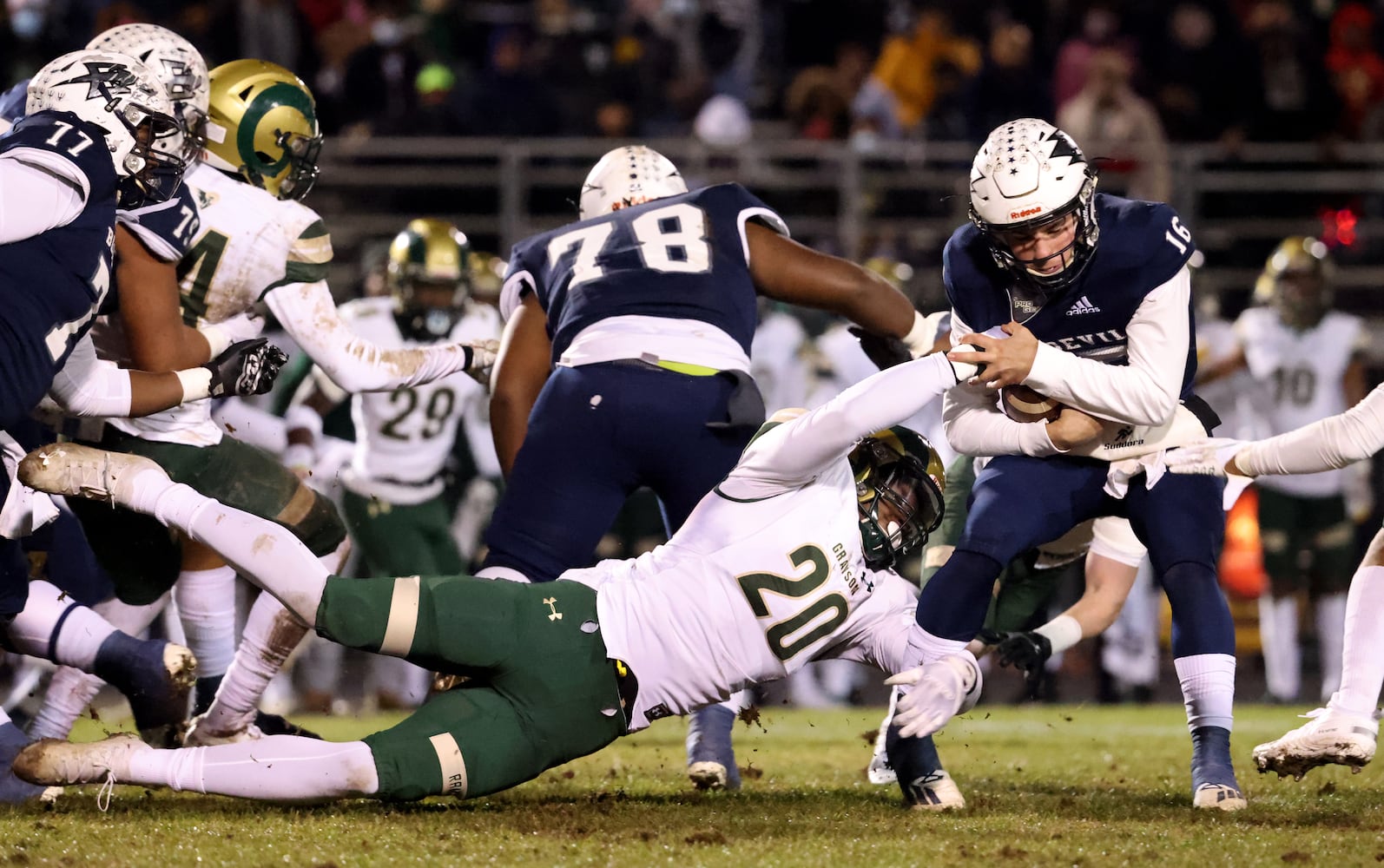 Dec. 18, 2020 - Norcross, Ga: Grayson defensive end Victoine Brown (20) tackles Norcross quarterback Mason Kaplan (16) for a short gain in the first half of the Class AAAAAAA semi-final game at Norcross high school Friday, December 18, 2020 in Suwanee, Ga.. JASON GETZ FOR THE ATLANTA JOURNAL-CONSTITUTION