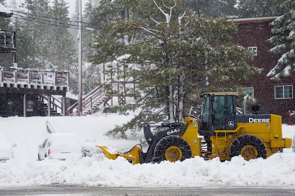 Snow is cleared from a road by tractor Thursday, Nov. 21, 2024, at Donner Ski Ranch near Truckee, Calif. (AP Photo/Brooke Hess-Homeier)