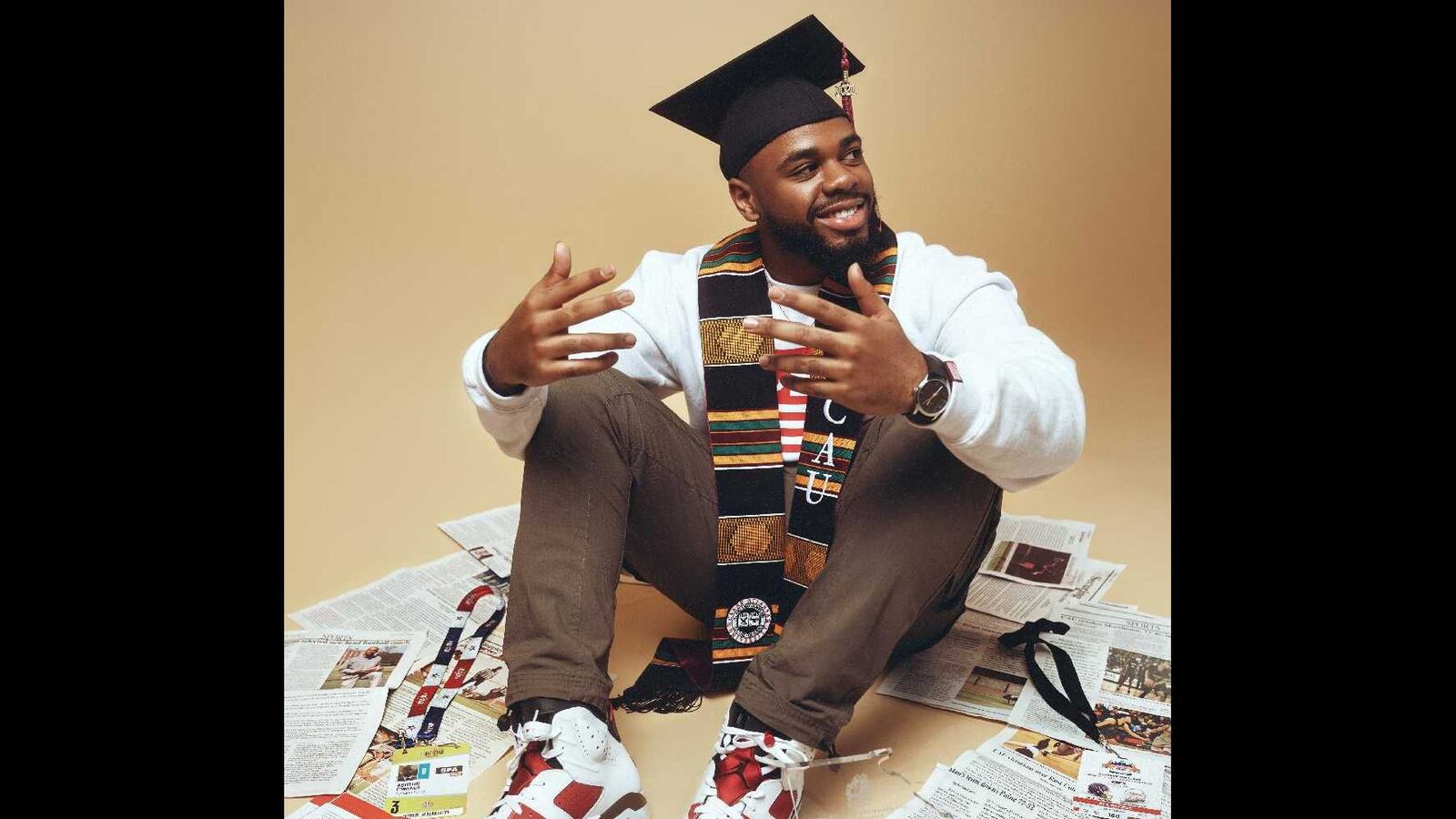 Clark Atlanta University graduating senior Ashton Edmunds is surrounded by some of the articles he's written. Edmunds, an aspiring sports journalist, plans to pursue his master's degree at Northwestern University. (Courtesy of Sean Bartley)