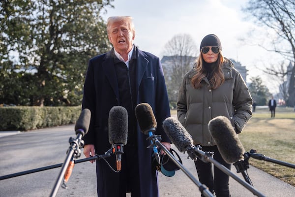 First lady Melania Trump looks on as President Donald Trump speaks with reporters before boarding Marine One on the South Lawn of the White House, Friday, Jan. 24, 2025, in Washington. (AP Photo/Evan Vucci)