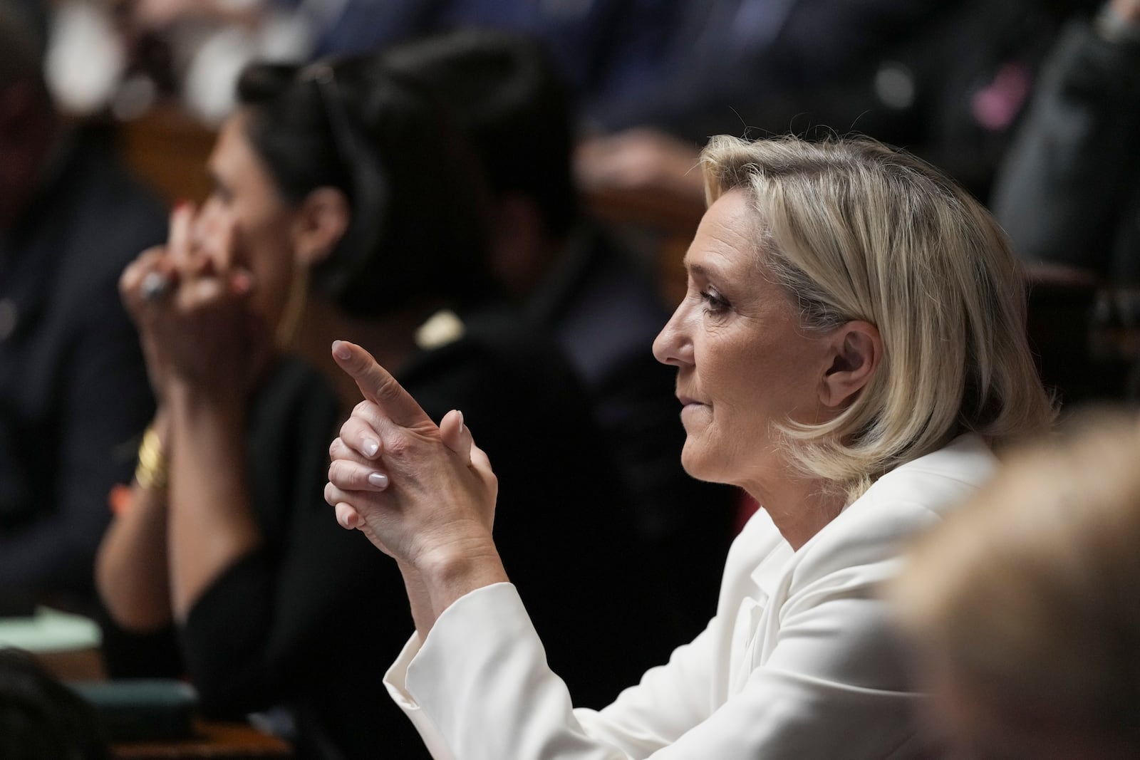 French far-right leader Marine Le Pen reacts during the speech of Prime Minister Michel Barnier at the National Assembly, in Paris, Tuesday, Oct. 1, 2024. (AP Photo/Thibault Camus)