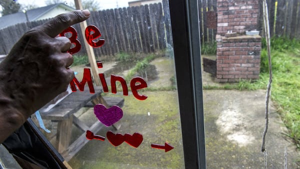 Sequita Thompson points to the white area on her family's patio where she said her grandson, 23-year-old Stephon Clark, lay dead after being shot Sunday, March 18, 2018, by police in Sacramento, Calif. Relatives, activists and Sacramento officials are questioning why officers shot at an unarmed black man 20 times, killing him, when he turned out to be holding only a cellphone in his own backyard.