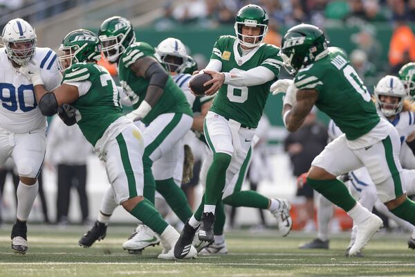 New York Jets quarterback Aaron Rodgers (8) hands off the ball to New York Jets running back Braelon Allen (0) during the second quarter of an NFL football game, Sunday, Nov. 17, 2024, in East Rutherford, N.J. (AP Photo/Adam Hunger)