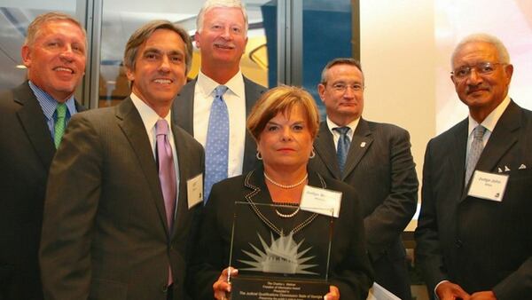 Judge Brenda Weaver (holding trophy) when she was still a member of the Judicial Qualifications Commission. The other JQC members — from left, Lester Tate, Jeff Davis, Robert Ingram, Richard Hyde and Judge John Allen — accepted the Georgia First Amendment Foundation’s 2014 Freedom of Information Award, later to be dubbed the Irony Award. (HANDOUT)