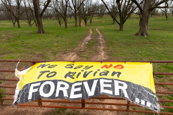 A view of a sign opposing a Rivian factory project in southern Walton and Morgan counties on Friday, March 8, 2024. The electric vehicle upstart announced more than two years ago plans to build a $5 billion plant, but said it is pausing the project Thursday. (Arvin Temkar / arvin.temkar@ajc.com)