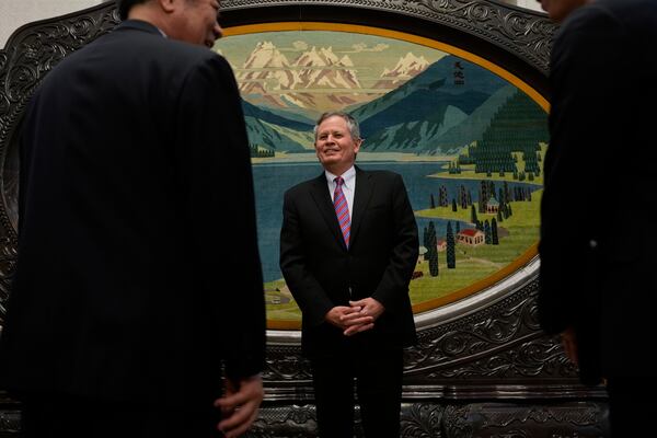 U.S. Senator Steve Daines, center, looks at Chinese Vice Premier He Lifeng, left before their meeting held in the Xinjiang Room at the Great Hall of the People in Beijing, China, Saturday, March 22, 2025. (AP Photo/Ng Han Guan, Pool)