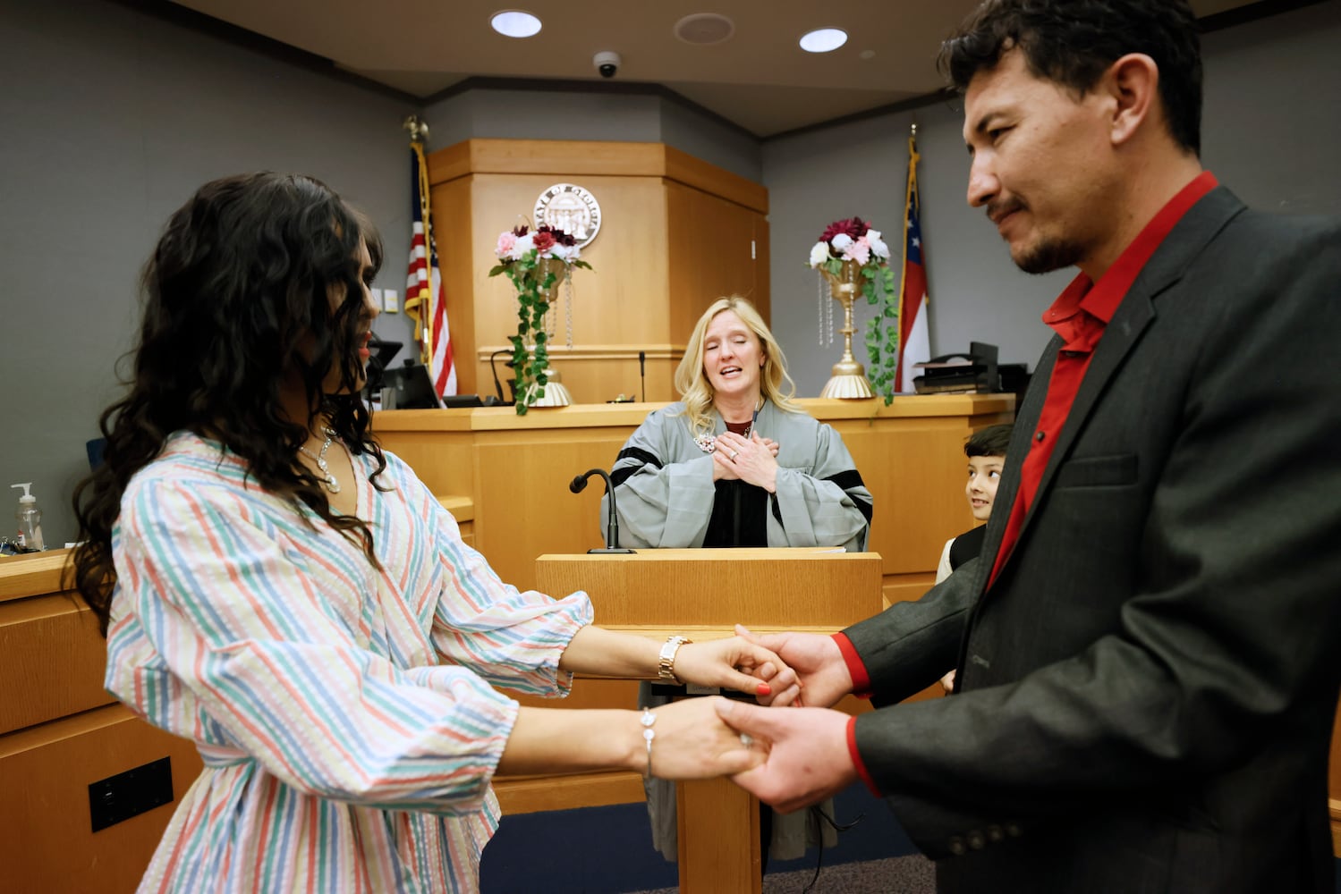 Chief Magistrate Judge Kristina Hammer Blum reacts as she presides over the wedding of  Sharif Mohibi and Farida Jafari in Courtroom 1C of the Gwinnett County Courthouse in Lawrenceville on Valentine’s Day, Tuesday, February 14, 2023. Miguel Martinez / miguel.martinezjimenez@ajc.com