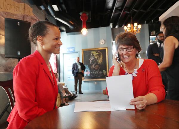 Adrienne White -- shown in 2016 with Anne Holton, the wife of Tim Kaine, the then-Democratic candidate for vice president -- is the state Democratic Party's vice chair of candidate recruitment. She says teh party is seeing more of its members running in down-ticket races. “People are stepping up to run in their communities, and they’re stepping up to reflect their values,” White said. Curtis Compton /ccompton@ajc.com