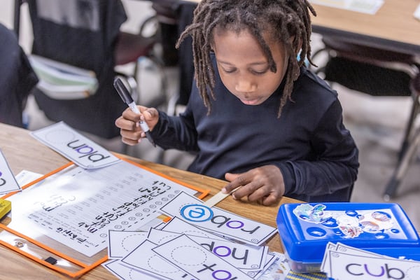 First grader Patrick Holloway writes and sounds out words during reading time at Kimberly Elementary School on Tuesday, Dec. 5, 2023. The school is one of eight Atlanta Public Schools sites participating in a pilot program supported by Cox Campus and the Atlanta Speech School. (Steve Schaefer/steve.schaefer@ajc.com)