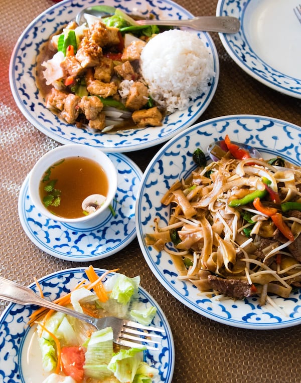 Zab-E-Lee in College Park offers a variety of Thai dishes: (clockwise, from top) Hot Garlic Pepper stir-fry with tofu, Drunken Noodles with beef, a side salad topped with ginger dressing and a cup of Tom Yum soup. CONTRIBUTED BY HENRI HOLLIS