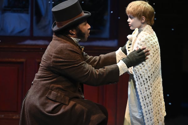 Christopher Hampton played Bob Cratchit and Emberlynn Wood was Tiny Tim in the 2023 Alliance Theatre production of “A Christmas Carol.”   Courtesy of Alliance Theatre/Greg Mooney