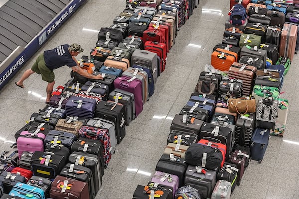 Rows of baggage on the floors in the baggage claim area of the domestic terminal at Hartsfield-Jackson International Airport on Tuesday, July 23, 2024, on the fifth day of a massive global technology outage that has severely impacted the operations of Delta Air Lines. John Spink/AJC