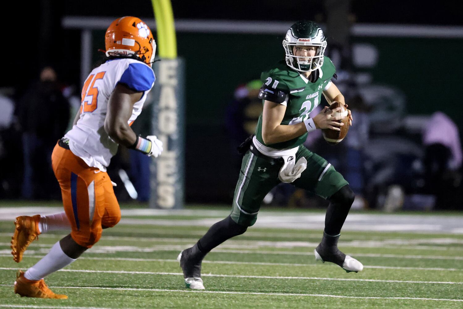 Dec. 11, 2020 - Suwanee, Ga: Collins Hill quarterback Sam Horn (21) runs against Parkview defensive end Kwesi Tillman (45) in the first half of the Class AAAAAAA quarterfinals game at Collins Hill high school Friday, December 11, 2020 in Suwanee, Ga.. JASON GETZ FOR THE ATLANTA JOURNAL-CONSTITUTION