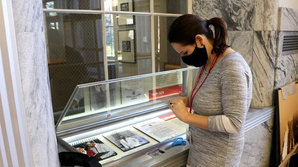 University of Georgia Special Collections Libraries archivist Jan Hebbard prepares graphics for display in an exhibit that will be part of a series of events to commemorate the 60th anniversary of its desegregation. (Courtesy of University of Georgia)