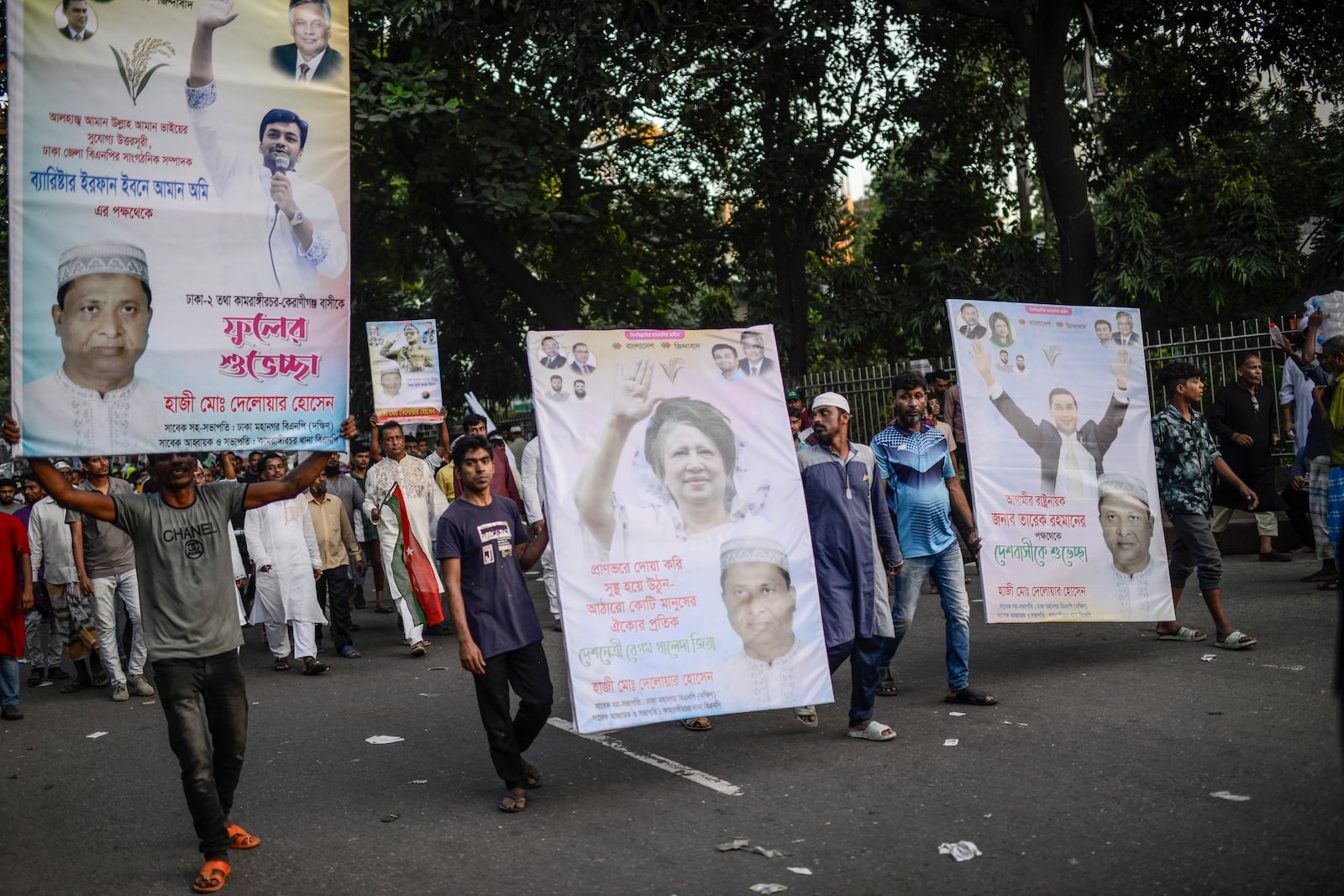 Bangladesh Nationalist Party (BNP) activists participate in a rally carrying the photographs of their leaders, in Dhaka, Bangladesh, Friday, Nov. 8, 2024. (AP Photo/Mahmud Hossain Opu)