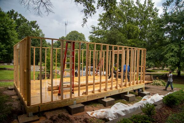 The C.D. Moody Construction company works on Charmaine Minnifield’s “Remembrance as Resistance” project in the African American burial grounds section at Oakland Cemetery June 11. Alyssa Pointer / Alyssa.Pointer@ajc.com