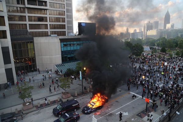 A police car is on fire Friday evening, May 29, 2020, in the street at CNN Center in Atlanta. (Photo:  ALYSSA POINTER / ALYSSA.POINTER@AJC.COM)