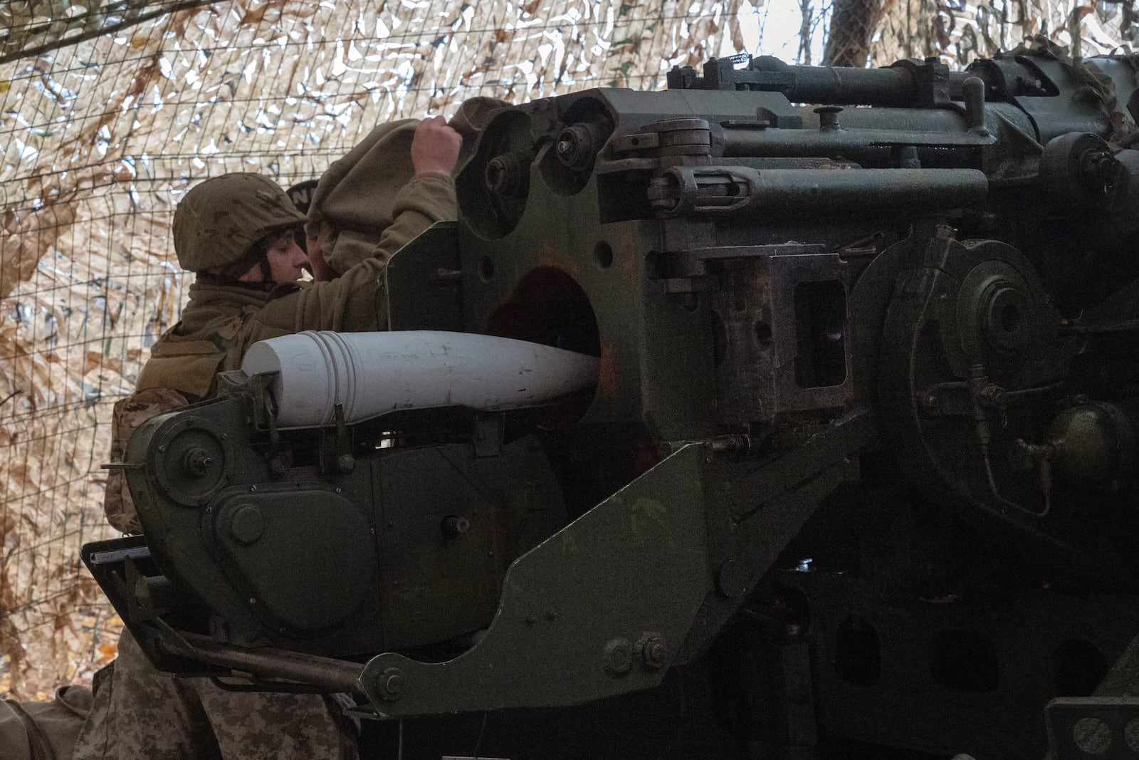 A serviceman of the 13th Brigade of the National Guard of Ukraine prepares to fire a Giatsint-B gun towards Russian positions near Kharkiv, Ukraine, Wednesday, Nov. 6, 2024. (AP Photo/Efrem Lukatsky)