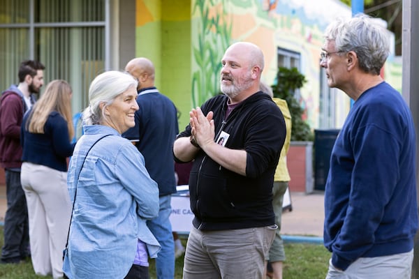 Josh Throneburg greets volunteers at IX Art Park in Charlottesville, Va., Thursday, Oct. 10, 2024. Charlottesville Democrats meet weekly to make phone calls, write postcards and send texts to get out the vote. (AP Photo/Ryan M. Kelly)