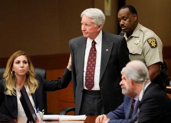 Standing amidst his attorneys, including Amanda Clark Palmer (left), Tex McIver is handcuffed and taken into custody after the guilty verdict Monday, April 23, 2018, in his murder trial. (Photo: Bob Andres bandres@ajc.com)