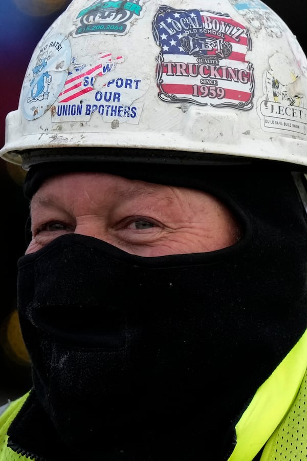 A construction worker bundles up as he works during cold weather in Northbrook, Ill., Thursday, Dec. 12, 2024. (AP Photo/Nam Y. Huh)