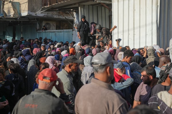 Residents gather in front of a bakery to get their share of bread in Deir al-Balah, Gaza Strip, Thursday, Nov. 21, 2024. (AP Photo/Abdel Kareem Hana)