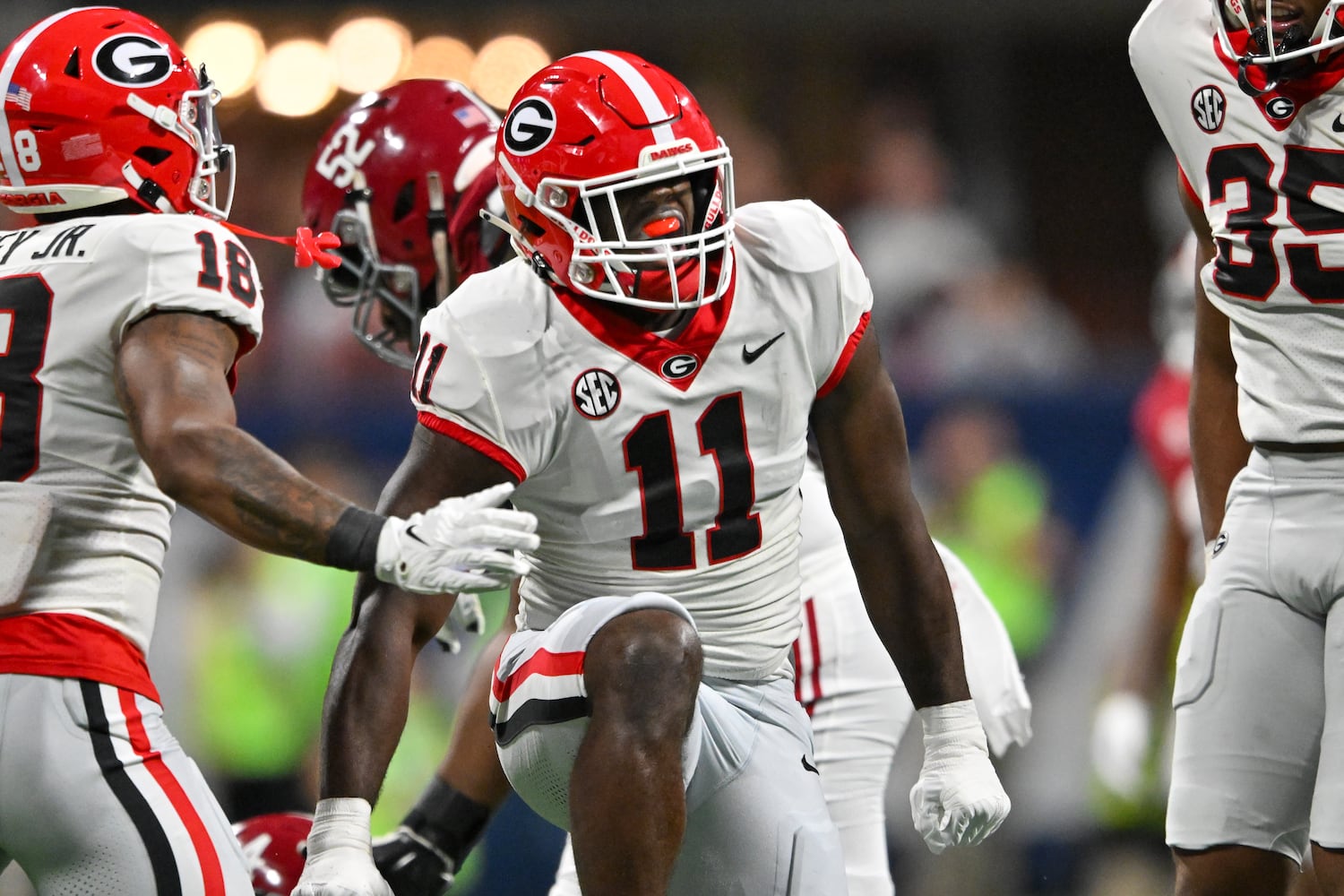 Georgia Bulldogs linebacker Jalon Walker (11) celebrates tackling Alabama Crimson Tide quarterback Jalen Milroe during the first half of the SEC Championship football game at the Mercedes-Benz Stadium in Atlanta, on Saturday, December 2, 2023. (Hyosub Shin / Hyosub.Shin@ajc.com)