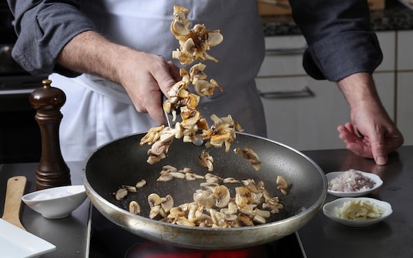 When your mushrooms are nicely seasoned and brown on the bottom, toss or stir them in the pan. (Abel Uribe/Chicago Tribune/TNS)