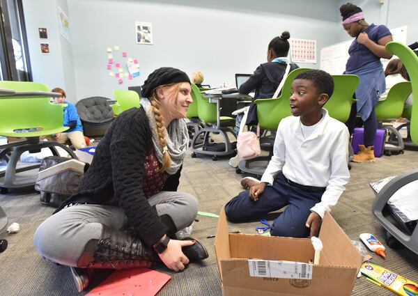 Social Study teacher Susannah Sawnson talks her student Timothy Lewis, 11, during 6th grade social study class at Brookhaven Innovation Academy in Norcross. The charter school is about to hit a major milestone. It has secured tax-exempt municipal bond financing to construct a million permanent school building. But the school will have to prove itself academically in upcoming years to keep its charter. HYOSUB SHIN / HSHIN@AJC.COM