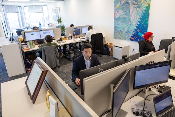 Employees work at the Atlanta Life Insurance Co. headquarters inside the Bank of America Plaza in Atlanta on Wednesday, Jan. 29, 2025. (Arvin Temkar/AJC)