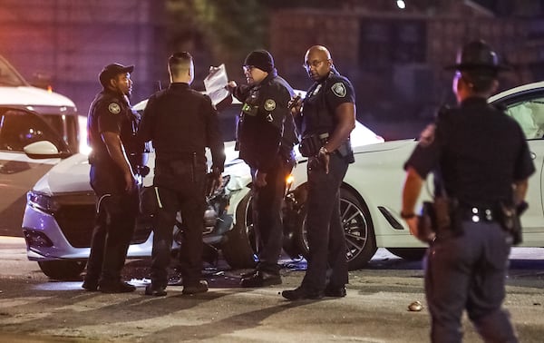 City of Atlanta and Capitol police focus their efforts on a pair of white wrecked vehicles Tuesday morning.