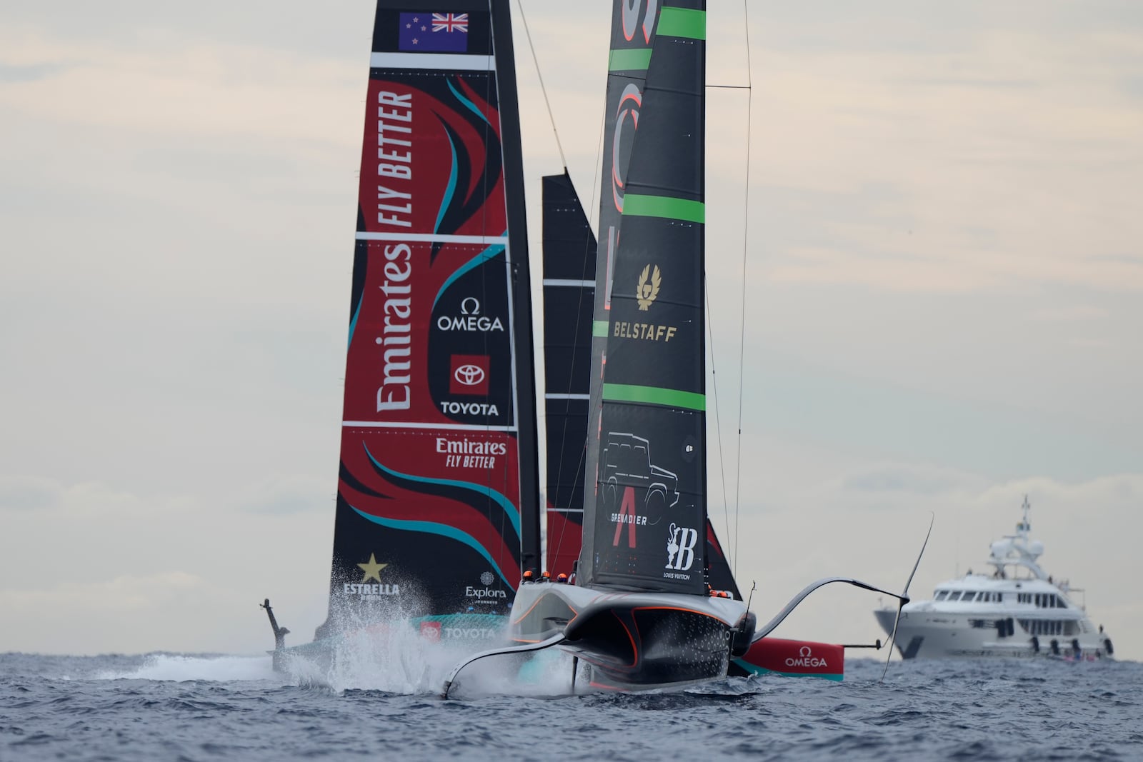 Ineos Britannia and Emirates Team New Zealand race during Louis Vuitton 37th America's Cup Day 5 race 7 in Barcelona, Spain, Friday, Oct. 18, 2024. (AP Photo/Bernat Armangue)