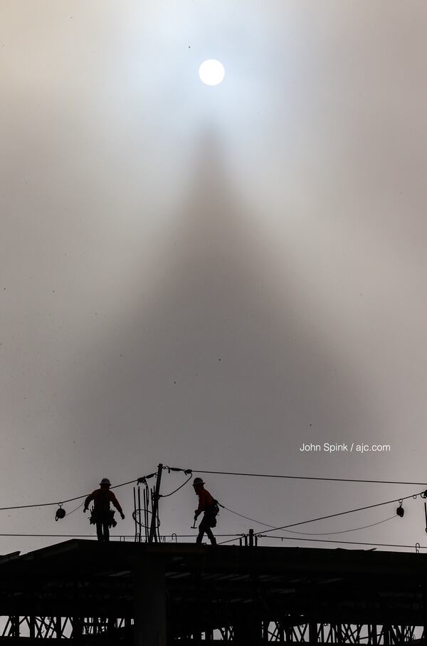 In the shadow of a foggy One Atlantic Center, work continues on the rising Atlantic Yards project in Atlanta.