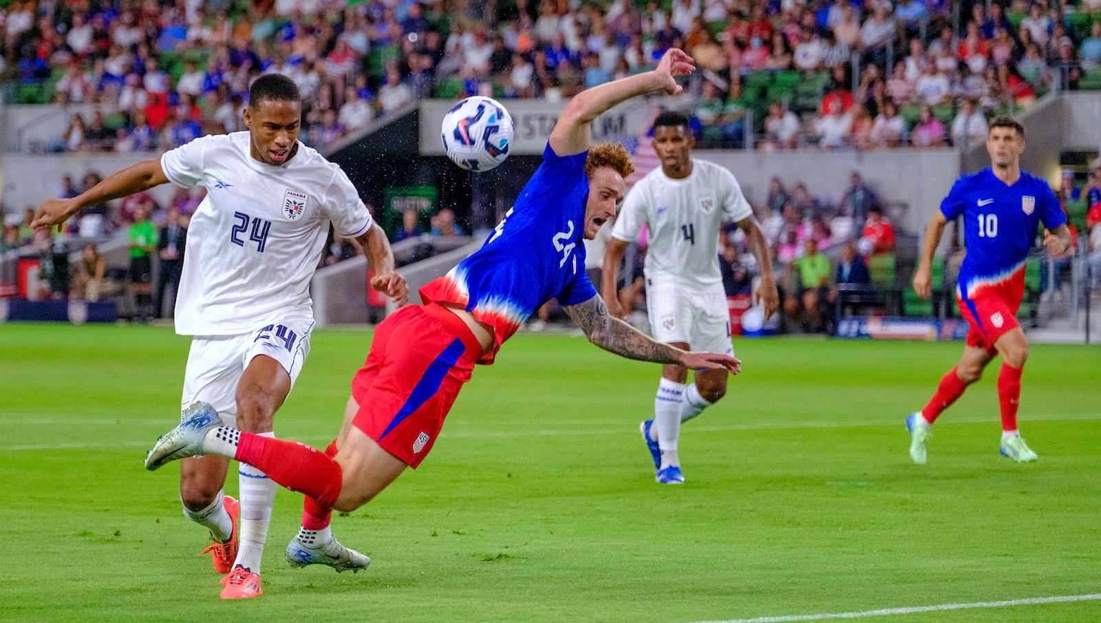 United States forward Josh Sargent (24) goes down after a tackle by Panama defender Edgardo Farina (24) during the first half of an international friendly soccer match, Saturday, Oct. 12, 2024, in Austin, Texas. (AP Photo/Rodolfo Gonzalez)