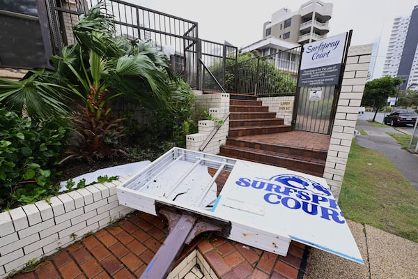 A damaged sign is seen outside an apartment building at Broadbeach following Cyclone Alfred on the Gold Coast, Australia, Saturday, March 8, 2025. (Dave Hunt/AAP Image via AP)