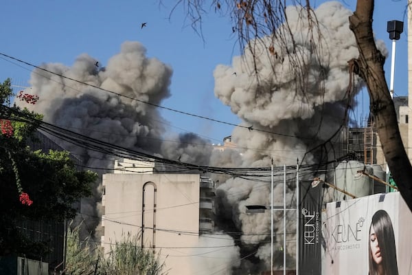 Smoke rises from a building collapsing after it was hit by an Israeli airstrike in Chiyah, south of Beirut, Lebanon, Sunday, Nov. 17, 2024. (AP Photo/Bilal Hussein)