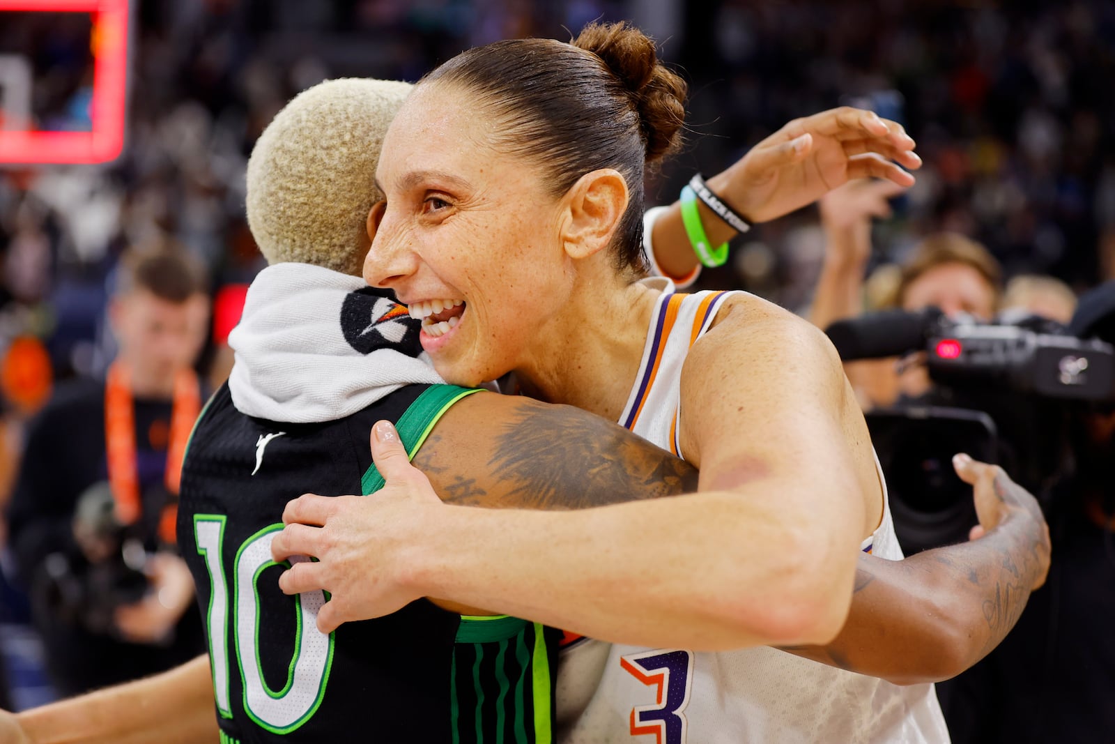 Phoenix Mercury guard Diana Taurasi (3) hugs Minnesota Lynx guard Courtney Williams (10) after Game 2 of a WNBA basketball first-round playoff game Wednesday, Sept. 25, 2024, in Minneapolis. (AP Photo/Bruce Kluckhohn)