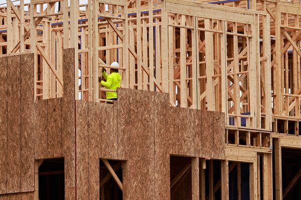 A worker continues construction on the foundation of a luxury townhouse at Foundry by JW Homes in Alpharetta. Construction lagged for years after the 2007-09 recession and has never caught up with metro Atlanta's population growth. Moreover, few homes are priced for first-time buyers. (Natrice Miller/natrice.miller@ajc.com)